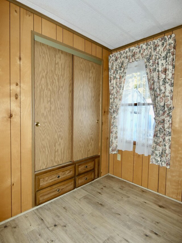 3924 W Jefferson Ave Unit 3924, Trenton, MI 48183 - spare room featuring wood finished floors, ornamental molding, and wooden walls
