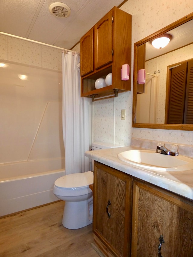 full bathroom with toilet, vanity, shower / tub combo with curtain, and hardwood / wood-style flooring