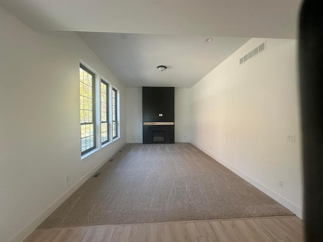 unfurnished living room with wood-type flooring