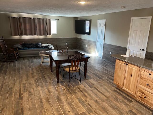 dining space featuring dark hardwood / wood-style floors and a textured ceiling