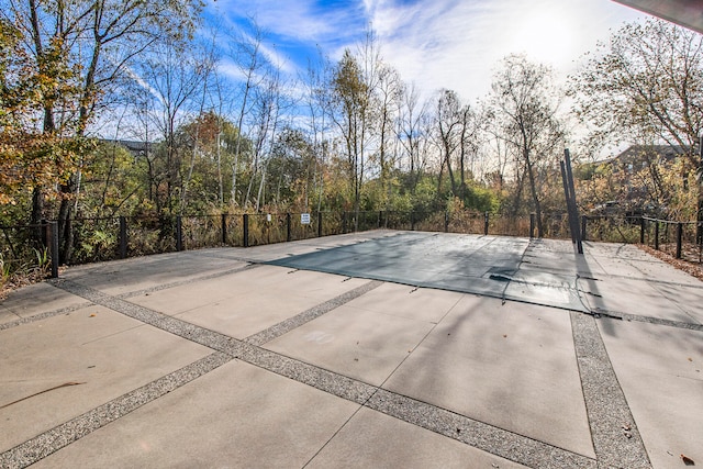 view of sport court with a covered pool