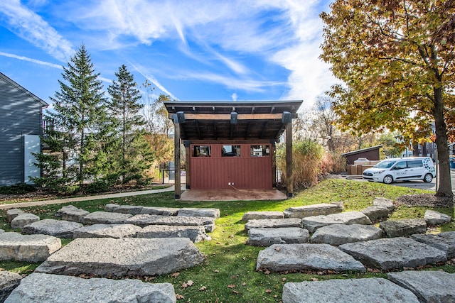 exterior space with a lawn and a storage unit