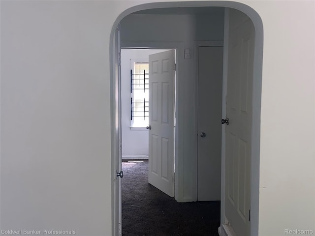 18498 Fielding St, Detroit, MI 48219 - hallway featuring arched walkways and dark colored carpet