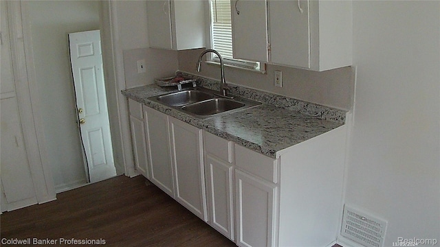 18498 Fielding St, Detroit, MI 48219 - kitchen with a sink, white cabinetry, dark wood-style flooring, and light countertops