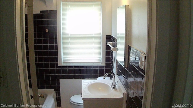 18498 Fielding St, Detroit, MI 48219 - bathroom with tile walls, toilet, vanity, and tub / shower combination