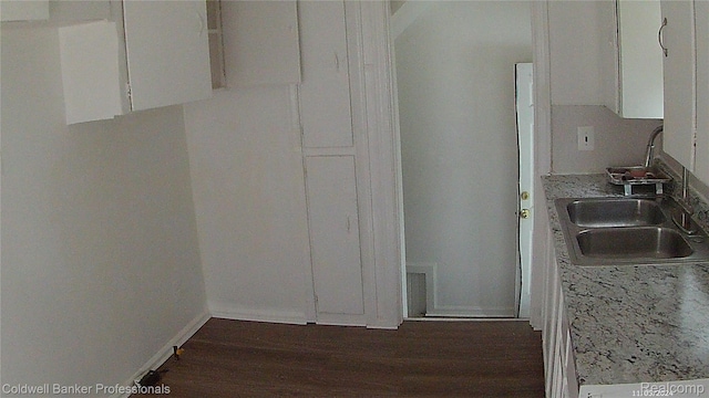 18498 Fielding St, Detroit, MI 48219 - kitchen featuring a sink, white cabinets, dark wood-style flooring, light countertops, and baseboards