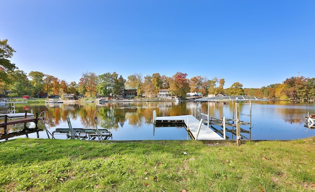 dock area featuring a water view and a yard