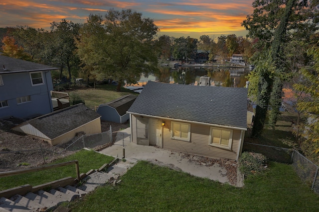 view of front facade with a water view and a yard