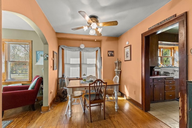 dining room with light wood-type flooring and ceiling fan