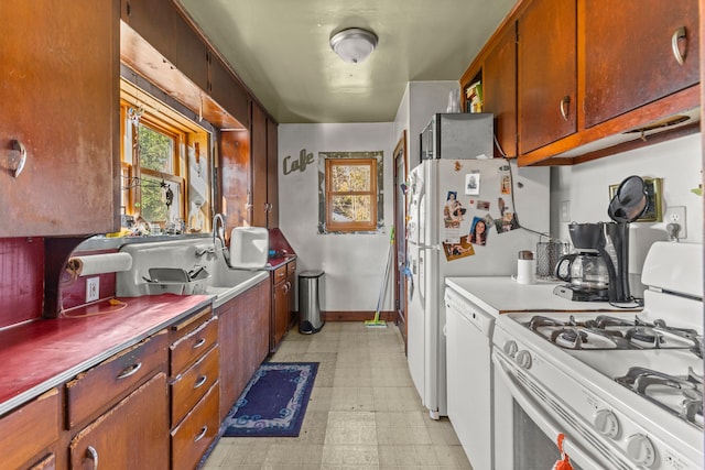 kitchen featuring sink and white appliances