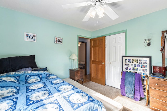 carpeted bedroom with ceiling fan and a closet