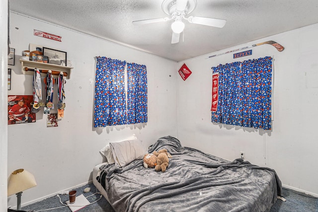 bedroom with carpet, ceiling fan, and a textured ceiling