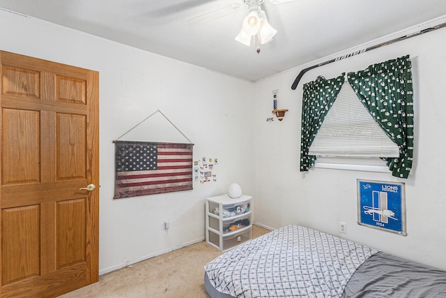 bedroom with ceiling fan and light carpet