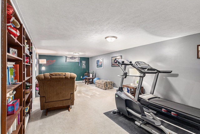 exercise area featuring a textured ceiling and carpet floors