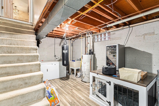 basement featuring wood-type flooring and gas water heater