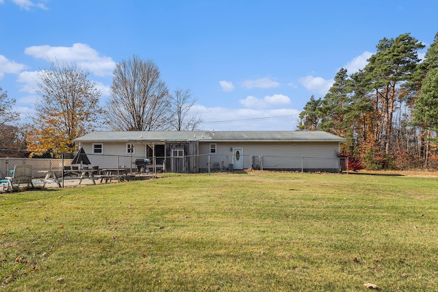 back of house featuring a yard