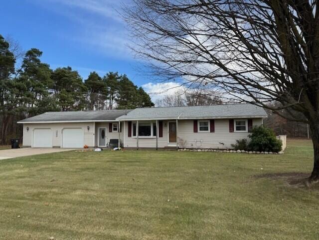 ranch-style home with a garage and a front lawn