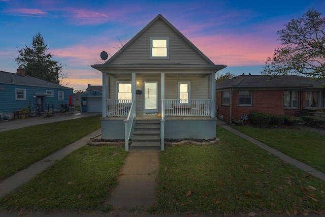 bungalow-style house with a lawn