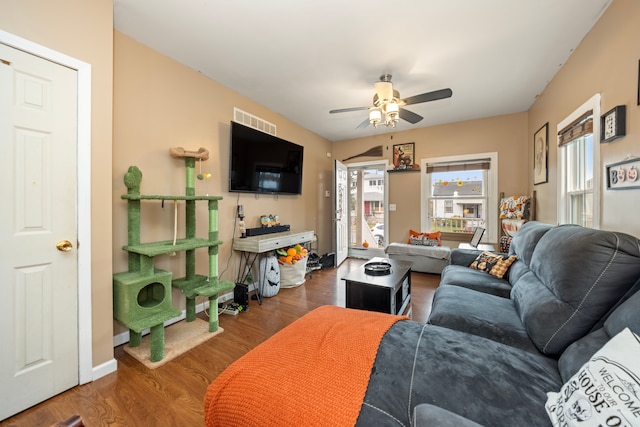 living room featuring dark hardwood / wood-style floors and ceiling fan