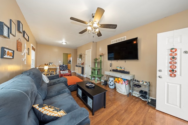 living room with ceiling fan and hardwood / wood-style floors