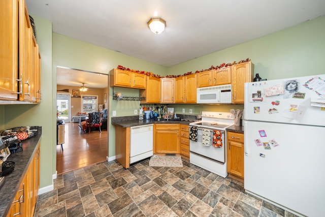 kitchen with white appliances, ceiling fan, and dark wood-type flooring