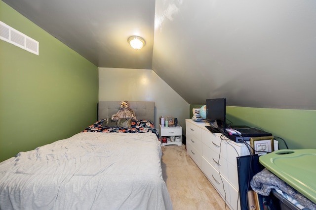 carpeted bedroom with vaulted ceiling