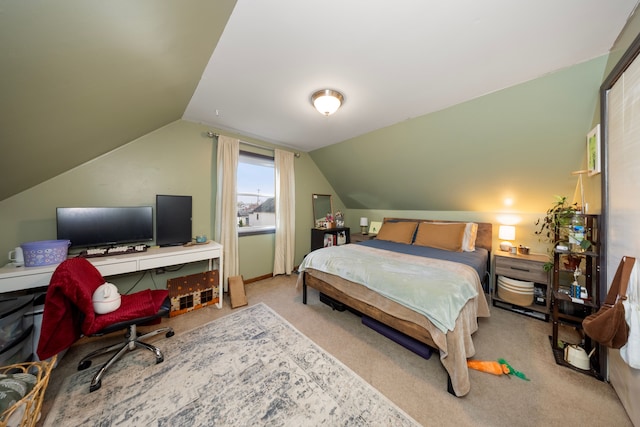 bedroom featuring light colored carpet and lofted ceiling