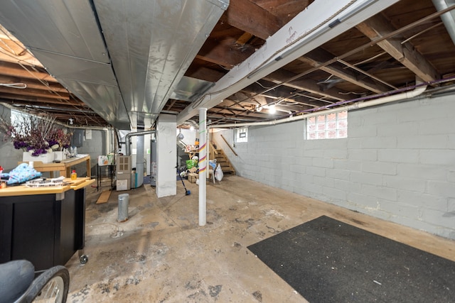 basement featuring electric panel and heating unit