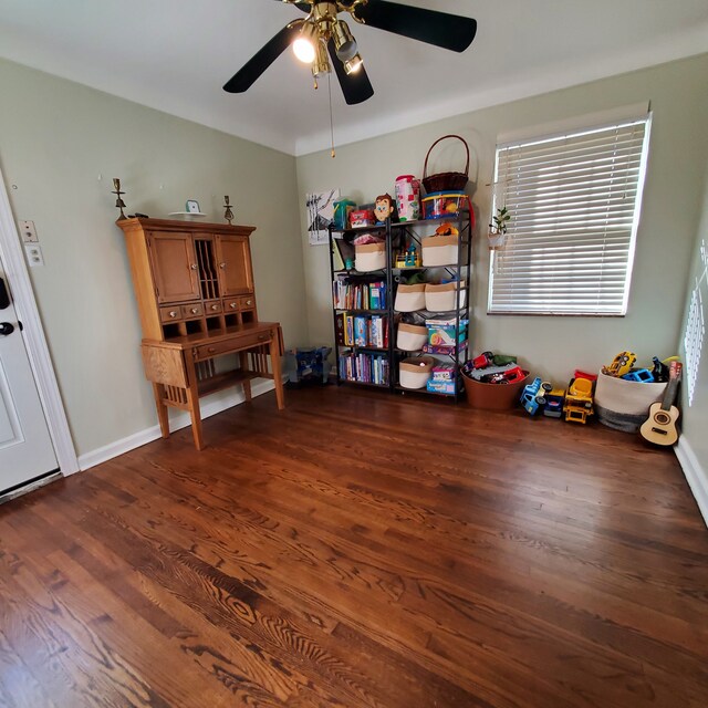 misc room featuring ceiling fan and dark wood-type flooring