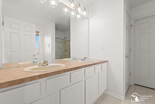 bathroom featuring tile patterned flooring, vanity, and a shower with door