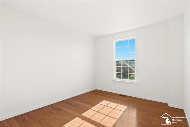 empty room with hardwood / wood-style floors