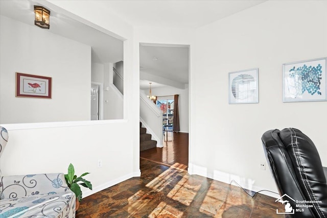 home office with a notable chandelier and dark wood-type flooring