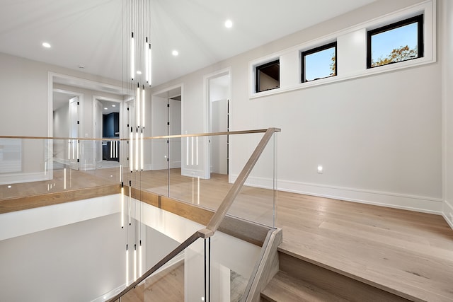 stairs with hardwood / wood-style flooring