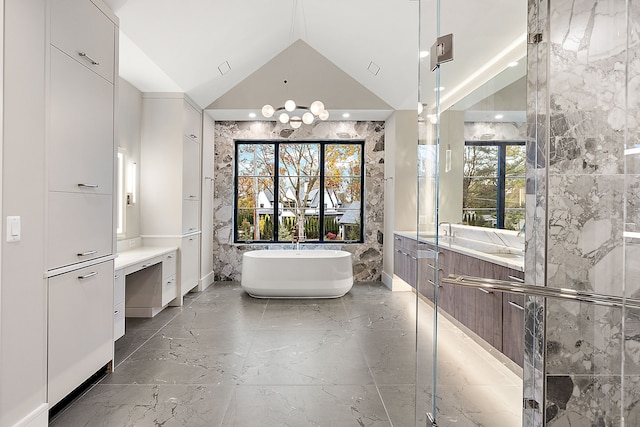 bathroom featuring plus walk in shower, vanity, and lofted ceiling