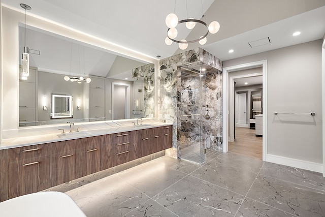 bathroom featuring vanity, an inviting chandelier, vaulted ceiling, and a shower with door