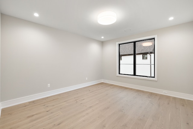 empty room with light hardwood / wood-style flooring