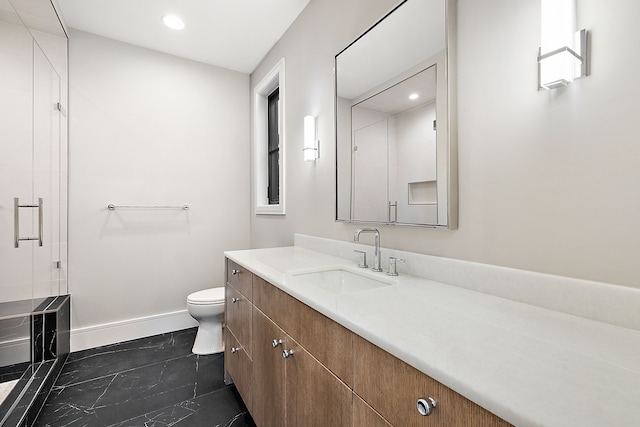 bathroom featuring tile patterned flooring, vanity, toilet, and walk in shower