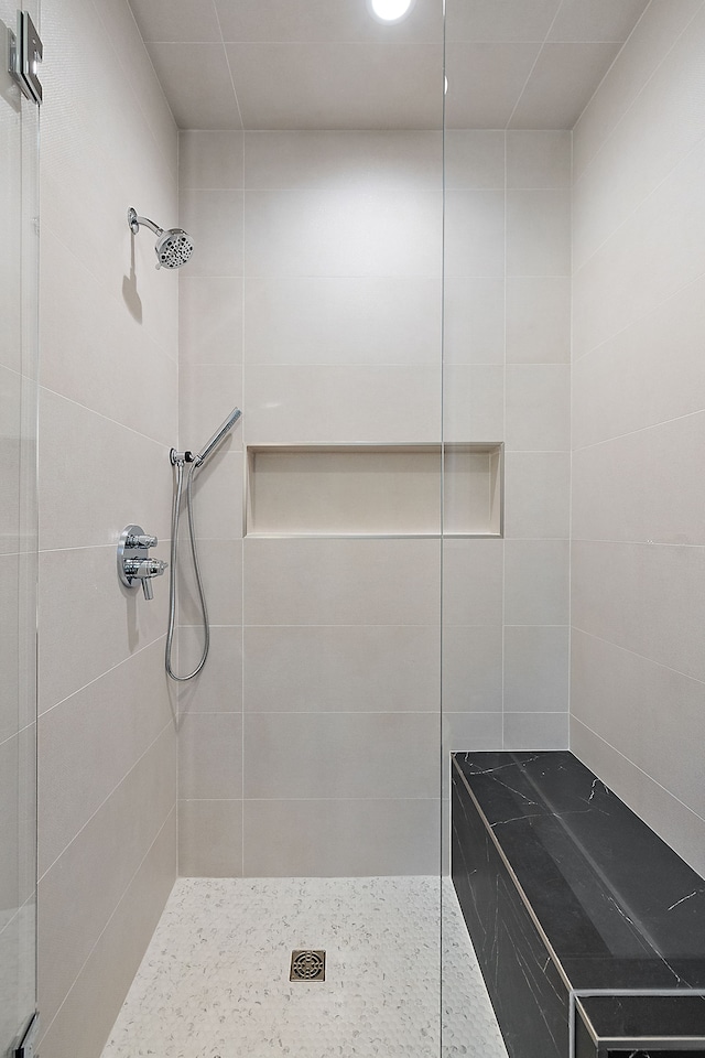 bathroom with a tile shower