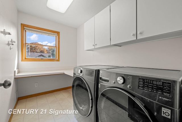 washroom with cabinets and washing machine and dryer