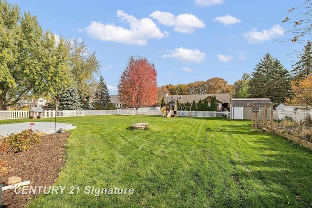 view of yard featuring a storage shed and a playground