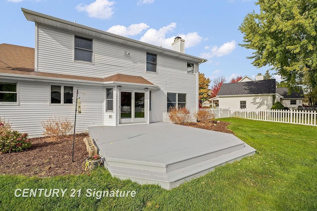 rear view of house featuring a yard and a deck