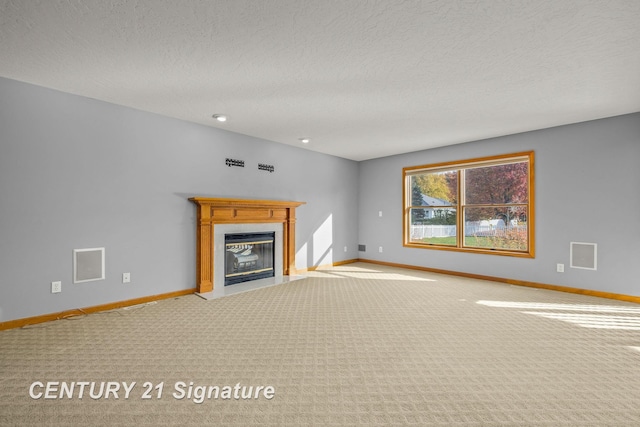 unfurnished living room with light carpet and a textured ceiling