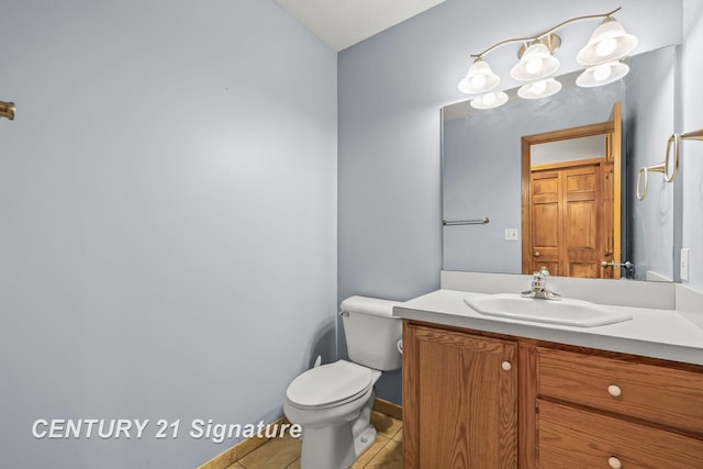 bathroom featuring tile patterned floors, vanity, and toilet