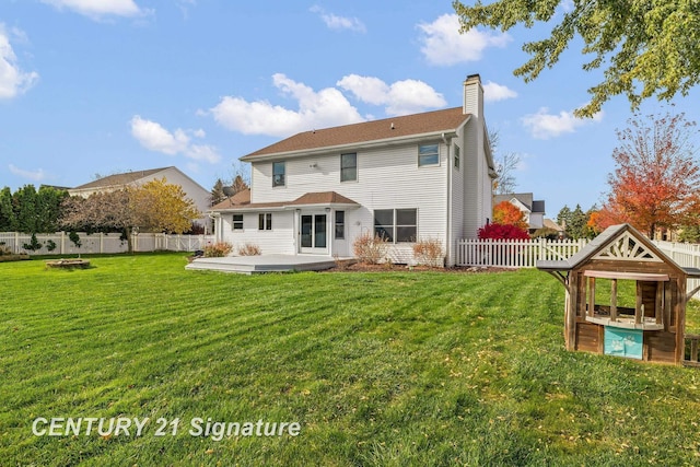 rear view of property featuring a yard and a patio area