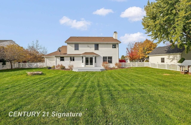 back of house featuring a lawn and a wooden deck