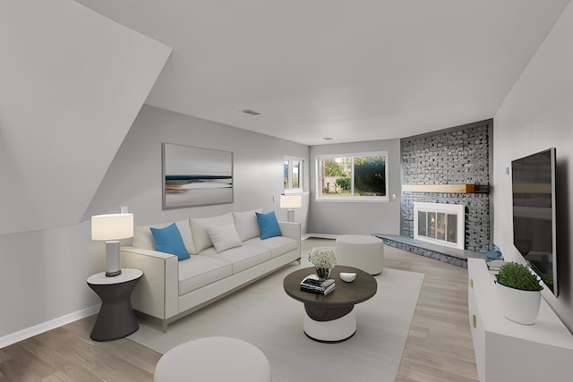 living room featuring a fireplace and light hardwood / wood-style floors