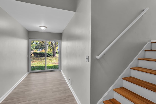 stairway with hardwood / wood-style flooring