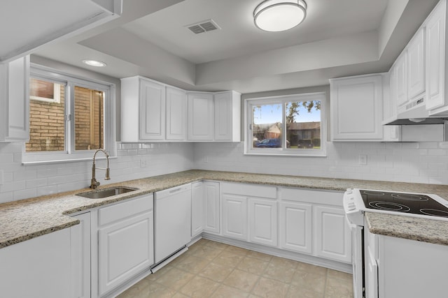 kitchen featuring white appliances, backsplash, premium range hood, sink, and white cabinetry