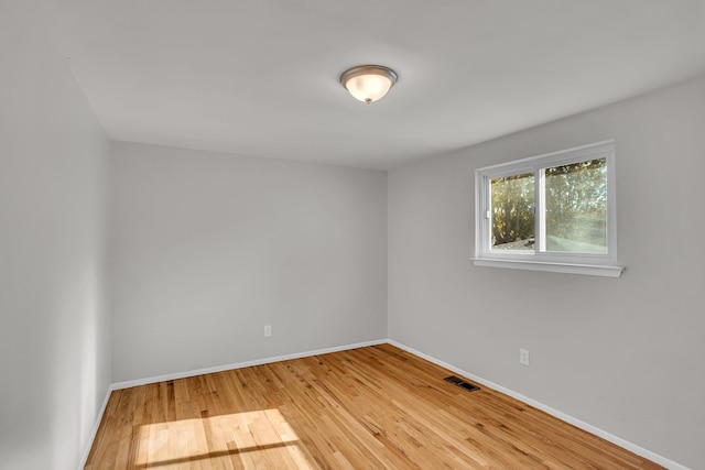 unfurnished room with hardwood / wood-style floors