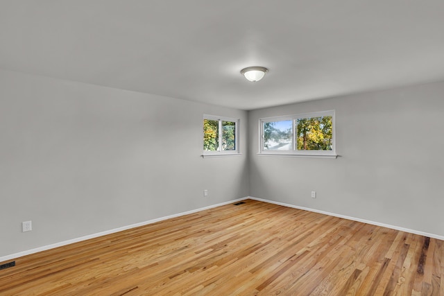 unfurnished room with light wood-type flooring